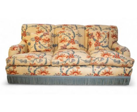 A modern three-seater sofa upholstered in floral chintz with blue tassels&nbsp; Formerly in 73 Chester Square, the London hom