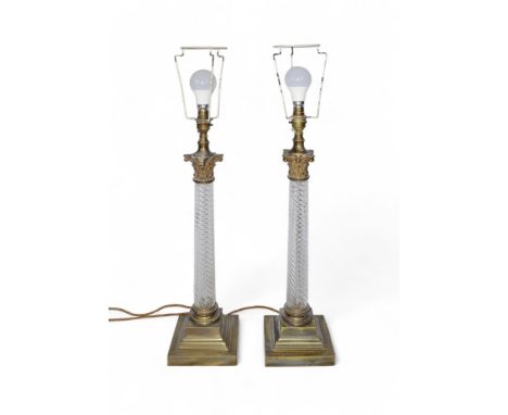 A pair of lamps, in the neoclassical style, with brass Corinthian capital and base. Glass spiral twist.  Property of a gentle