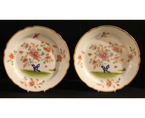 A pair of early 19th century English porcelain shaped circular dessert plates, probably Spode, painted with an Indian tree de