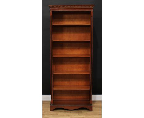 A 19th century style open bookcase, dentil cornice above five shelves, bracket feet, 181cm high, 75.5cm wide, 30.5cm deep 