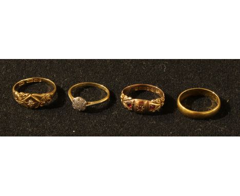 A gold wedding band, unmarked, probably 22ct, 3.7g; an 18ct gold ring, set with a single diamond chip, 3.7g; an 18ct gold flo