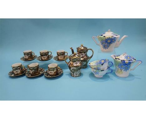 A Maling coffee set comprising coffee pot, cream jug and six cans and saucers, of a gold and white floral design, numbered 35