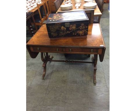 A reproduction burr walnut sofa table