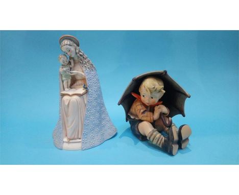 A large Hummel figure of a boy holding an umbrella and a Goebel figure of the 'Madonna' 