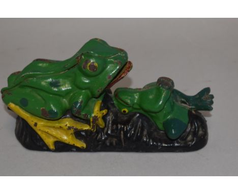 A vintage cast iron money box or bank in the form of a mechanical frog