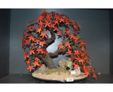 A vintage faux cherry tree with scenic base and mudman figure