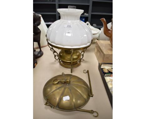 A Victorian oil burning lamp with foliate style hanging bracket and brass gimbal.