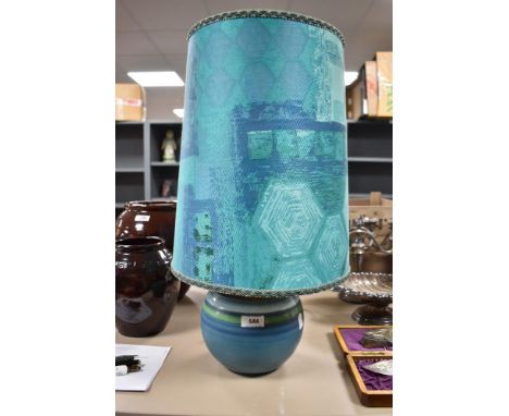 A mid century side or table lamp possibly by Denby having green and teal glaze with matching vintage shade.