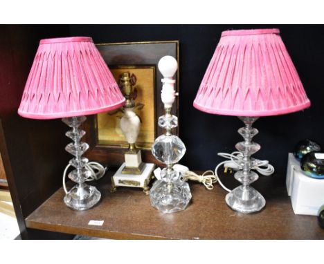 Three mid century kitsch cut glass table lights with a similar onyx and ormolu decorated lamp base.