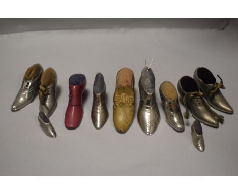 Eleven vintage pin cushions in the form of ladies shoes or boots, most being cast in pewter.