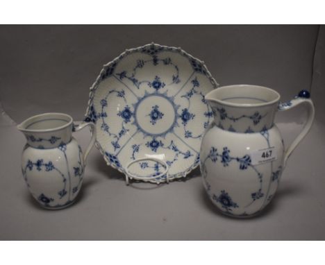 Three peices of modern Royal Copenhagen including two milk jugs and a bowl with pierced edge work.