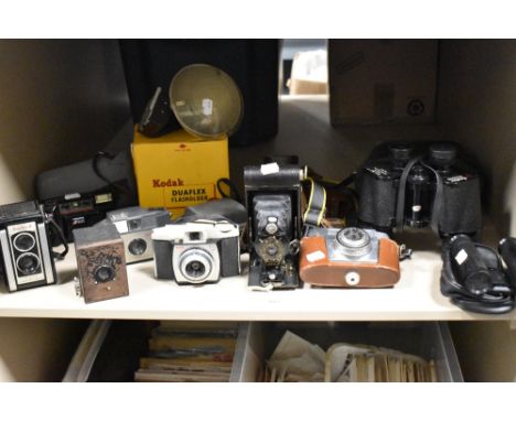 A selection of vintage cameras including Kodak 44B, Duaflex II, Brownie 127, A-120, Halina AF810 and a pair of Swallow 10x50 
