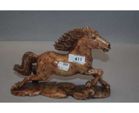 A vintage soap stone carved figure study of a mustang horse