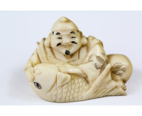 A 19th Century Carved Netsuke, 'Carp and Fisherman', approx 4 cms l, with character marks to base.