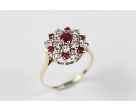 A 9ct Ruby and CZ Cluster Ring, set with one central 3.5mm ruby and six 2.2 mm rubies, size P, approx 2.8 gms.