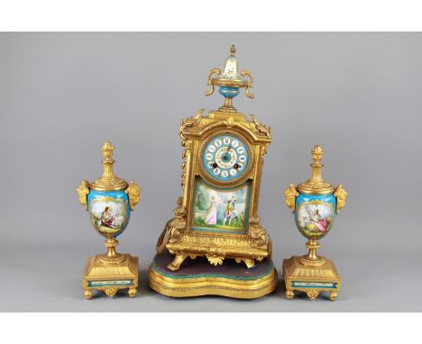 A 20th Century French Brass and Porcelain Clock and Garniture. The clock and garniture painted with classical scenes, approx 