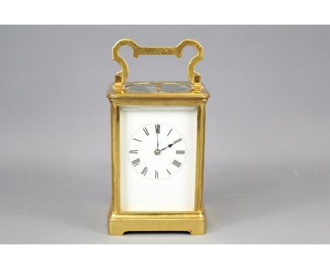 A 19th Century French Brass Carriage Clock. The clock having a bevelled glass panel enclosing a white enamel face with Roman 