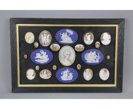 A Victorian Framed and Glazed Vignette, comprising of four Wedgwood cobalt Jasper-ware ovals with classic themes in white rel
