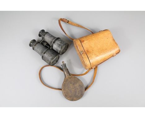 A Pair of WWI Binoculars.The binoculars together with a leather powder flask embossed with a seated Labrador dog.