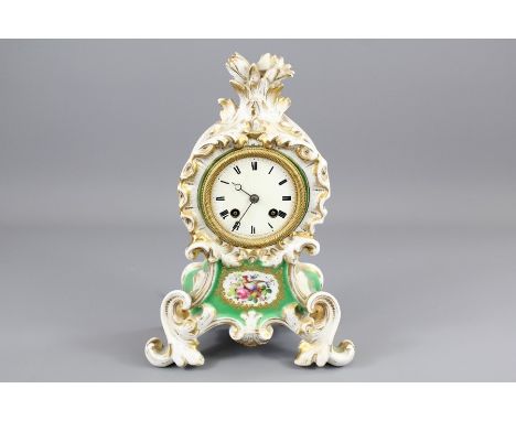 A 19th Century French Gilt Porcelain Mantel Clock. The clock having a enamel face with Roman dial, hand painted floral vignet