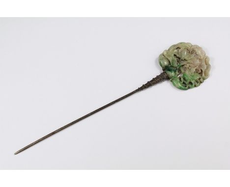 A Chinese Carved Hair Pin. The pin with a carved jade finial depicting a bird amongst blossoms, approx 7 cms.