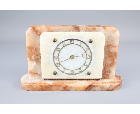 An Art Deco Rose Coloured Alabaster Mantel Clock. The clock having a brass numeric chapter dial, Gold Medal Winner, approx 27