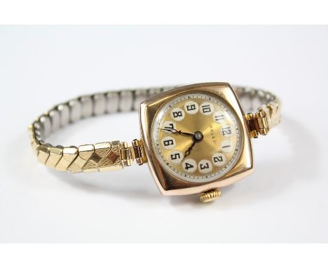 A Lady's Vintage 1921 9ct Gold Rolex Watch. The watch having a gold engine-turned face with silver circular numeric dial, Rol