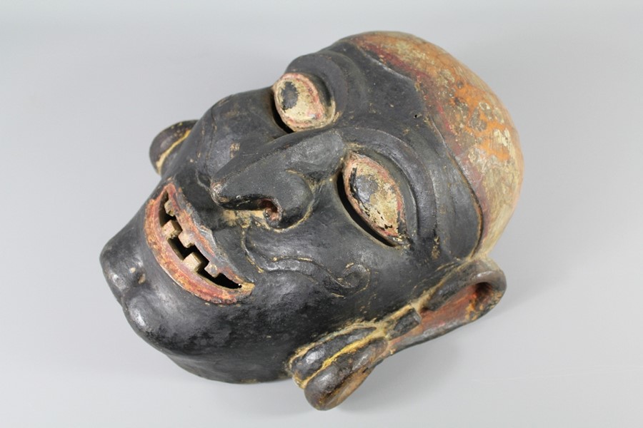 An Indonesian Wood Carved Mask. The mask carved in relief with