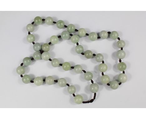A String of Chinese Jade Beads, individually knotted, approx 70 cms l.