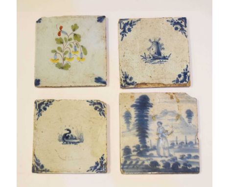 Four 18th Century Delftware tiles, comprising one polychrome with flowering plant, and three blue decorated with a figure in 