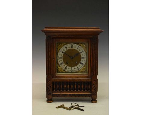 Early 20th Century German walnut cased mantel clock having a silvered Roman chapter ring dial with gilt masked spandrels, sin