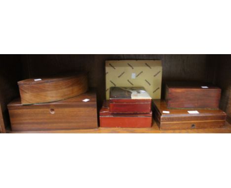 A shelf containing a selection of wooden and other storage boxes