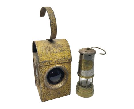 HCC yellow painted railway lamp and a British Coal Mining Company Wales brass miners lamp, HCC lamp H