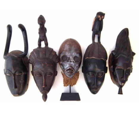 Five Ivory Coast masks, the tallest measures 47cm high       All lots in this Tribal and African Art Sale are sold subject to