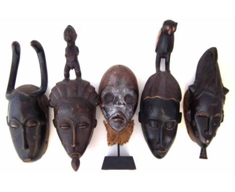 Five Ivory Coast masks, the tallest measures 47cm high       All lots in this Tribal and African Art Sale are sold subject to