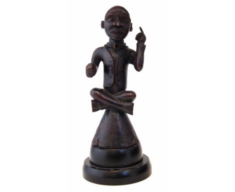 Kongo figure of a cross legged seated male pointing skywards, 37cm high excluding base    All lots in this Tribal and African