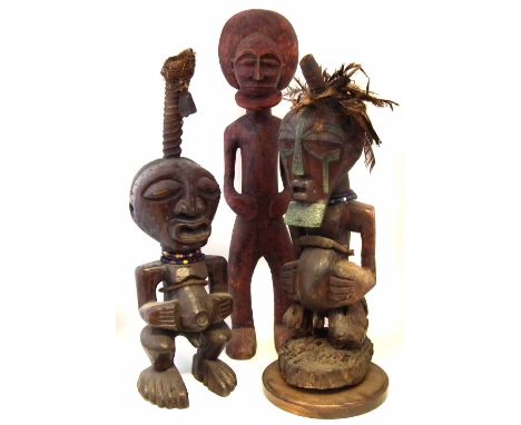 Two Songye power figures and a Chokwe figure, the largest measures 102cm high     All lots in this Tribal and African Art Sal