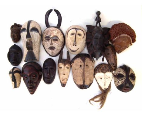 Fifteen African masks carved in various tribal styles, the largest measures 22cm high     All lots in this Tribal and African