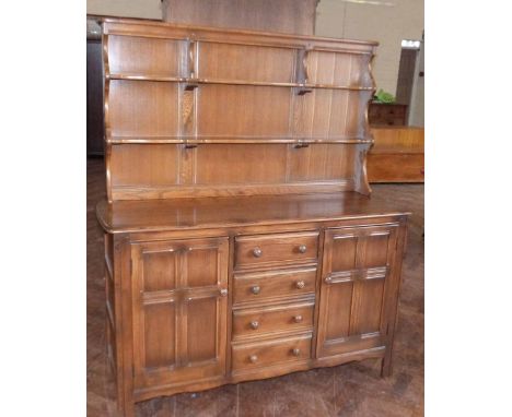 Elm Ercol dresser complete with plate rack, 146cm wide. Condition report: see terms and conditions