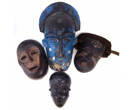 Cameroon blue painted mask, also a Pende mask, Lega mask and a Kuba mask, the largest measures 46cm high     All lots in this