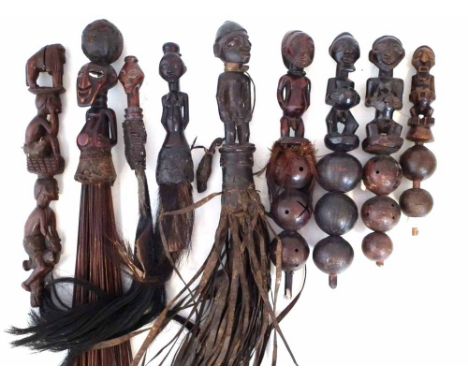 Four fly whisks, four rattles and a wand top, carved in various tribal styles, the largest piece measures 31cm high     All l