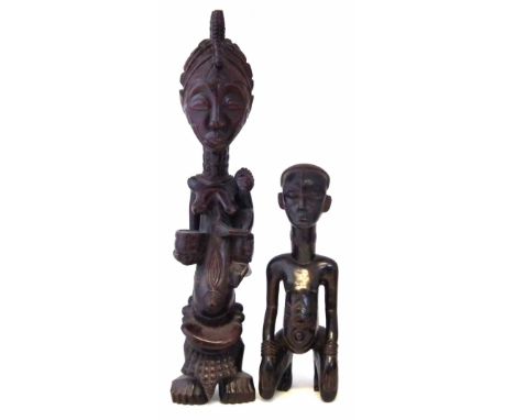 Lulua maternity figure and one other kneeling figure, 68cm high    All lots in this Tribal and African Art Sale are sold subj