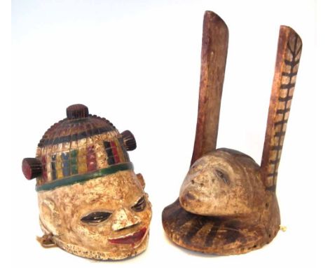 Yoruba Apasa mask and one other painted helmet mask, the Apasa mask measures 39cm high     All lots in this Tribal and Africa