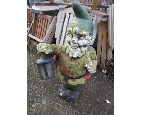 A LARGE CONCRETE STATUE LIGHT OF A GARDEN GNOME