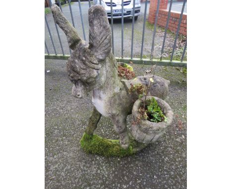A CONCRETE PLANTER STATUE DEPICTING A DONKEY