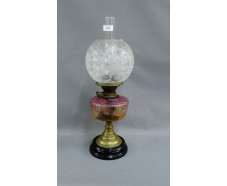 Oil lamp with rose coloured moulded glass well and etched glass shade