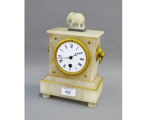 White hardstone mantle clock with lion mask head handles to side, surmounted by an elephant, enamel dial with Roman numerals 