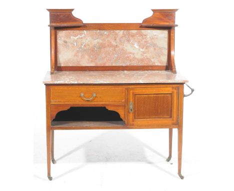 An Edwardian mahogany and marble top washstand Having a raised marble panel back above a conforming rouge marble slab top ove