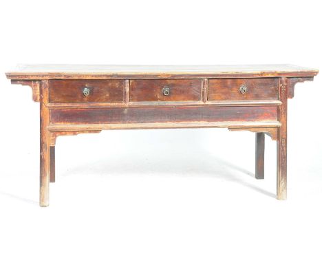 A Chinese Huanghuali style side table The planked top with mitred edges, above three fitted drawers with, metal work lotus fl