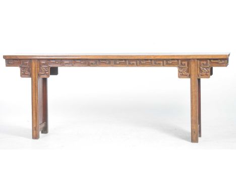 A large Chinese Huanghuali style altar table The rectangular single plank flat top, supported on reeded plank side supports, 